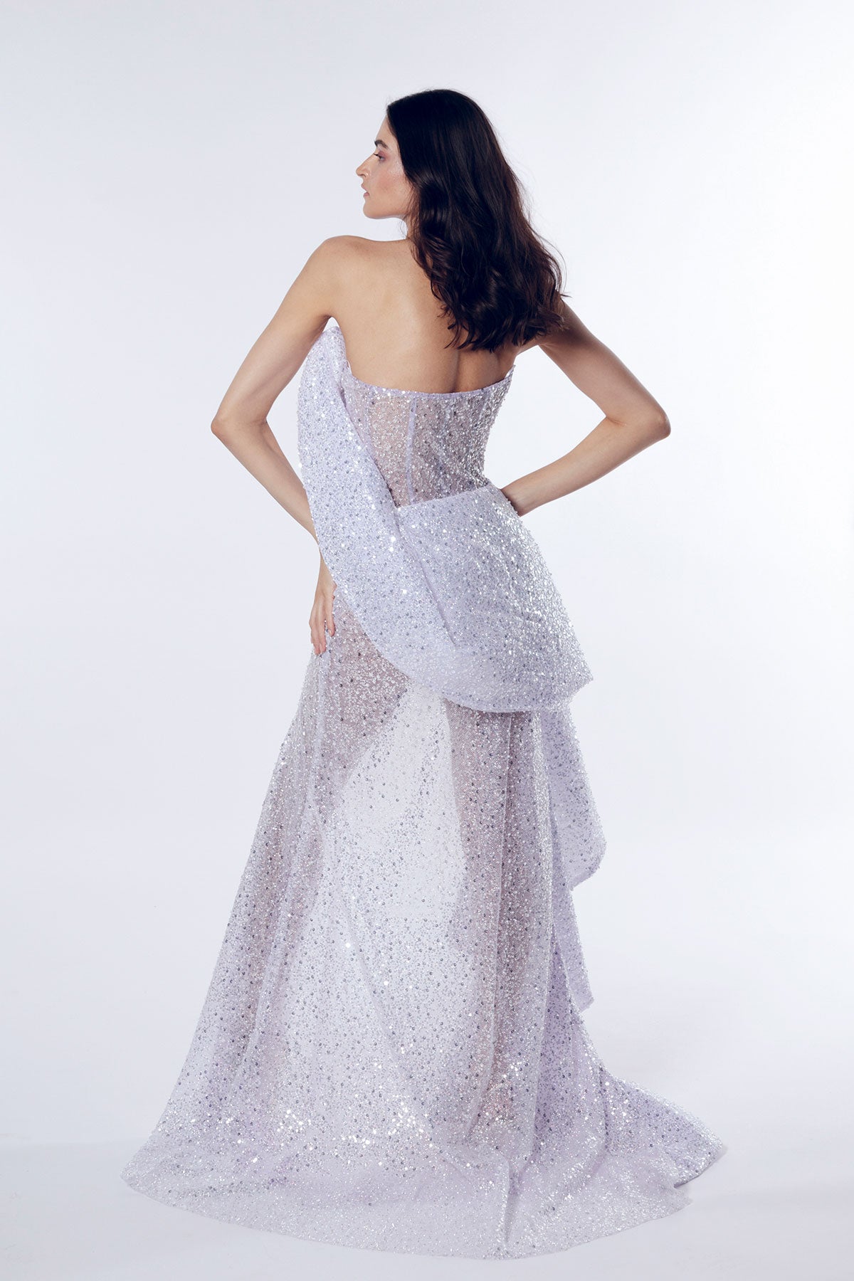 A strapless gown with a thigh-high slit made of light purple shimmering