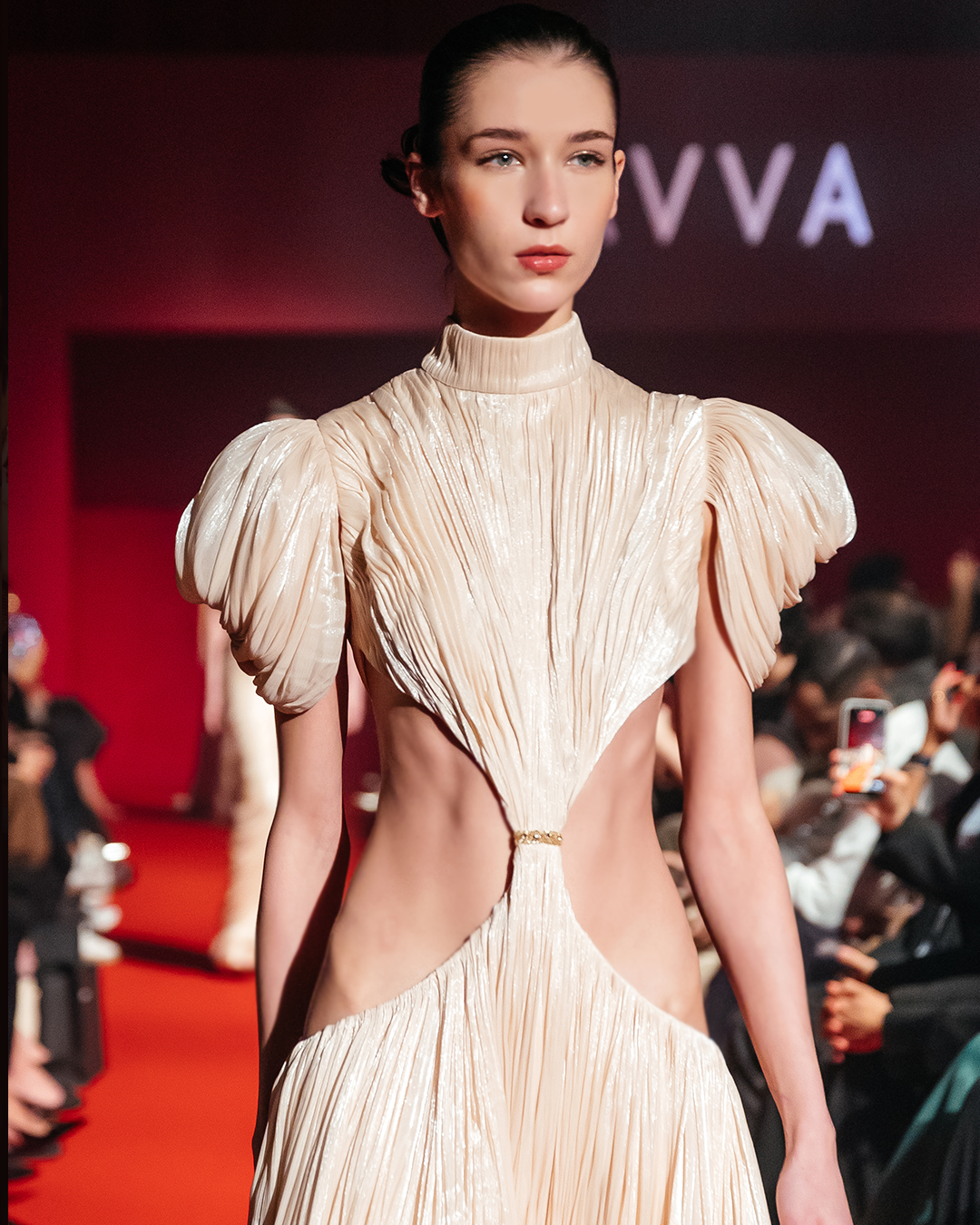 Shimmering, finely pleated fabric, high neckline and short, voluminous puffed sleeves