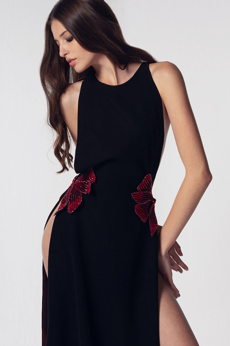 Open sides black crepe dress with appliqué flowers on the waist with metallic red lining
