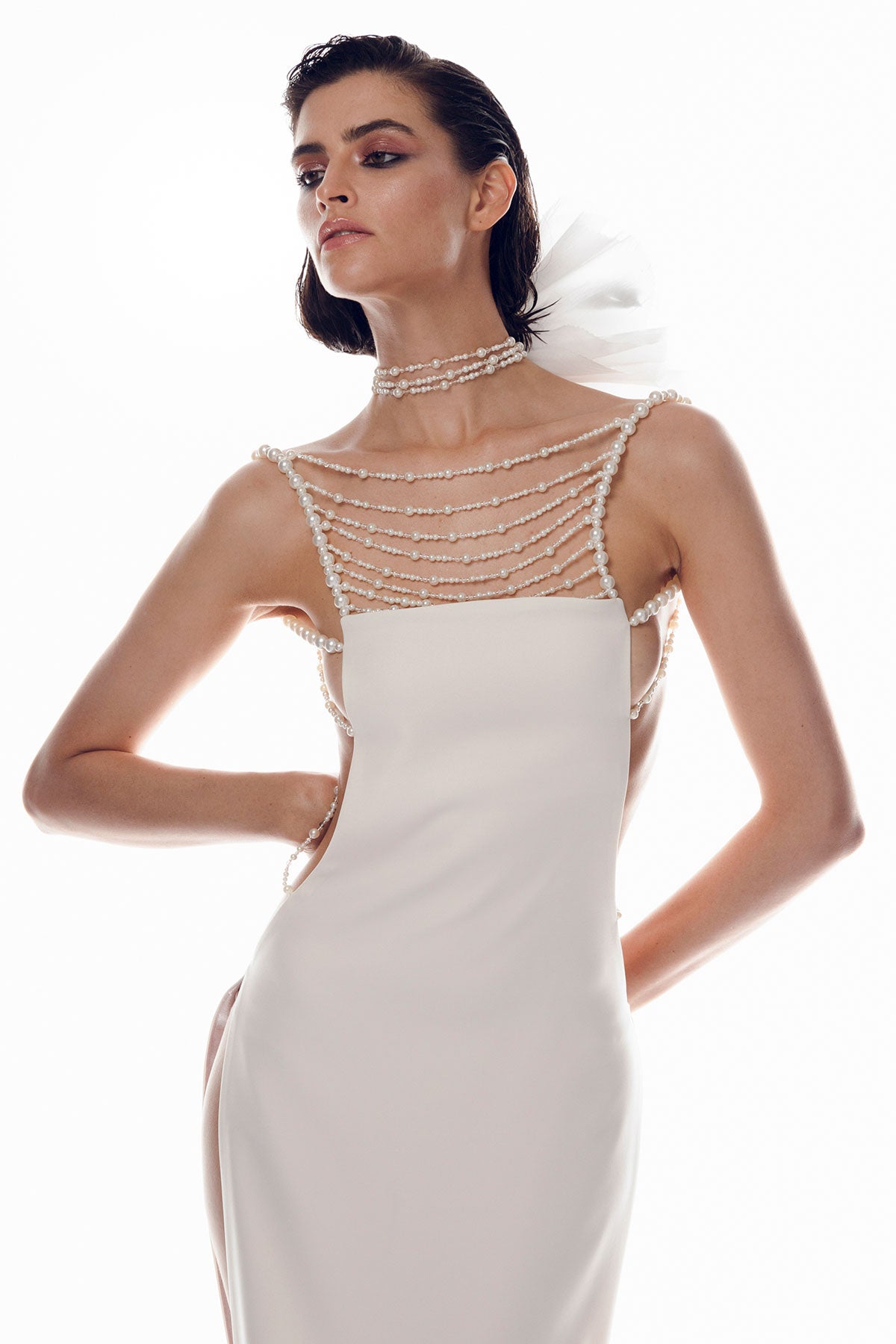 Off-white crepe dress features a unique design with open sides and an open back.