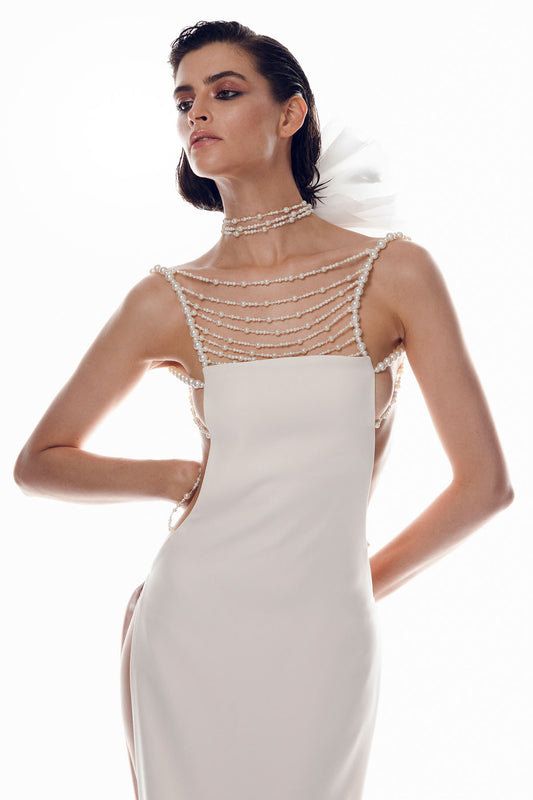 Off-white crepe dress features a unique design with open sides and an open back.